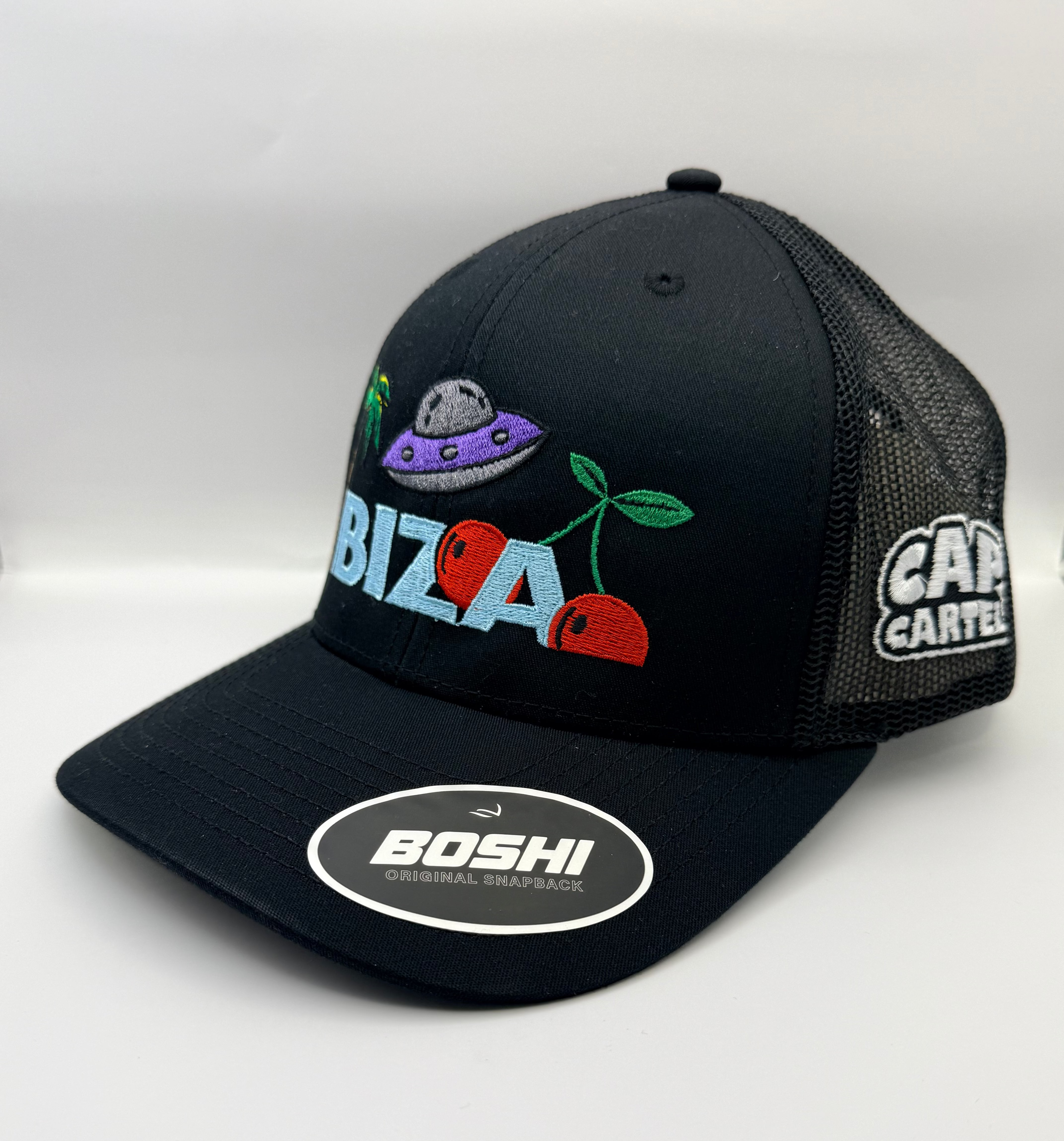 Black cap with colorful designs and brand logos on a white background